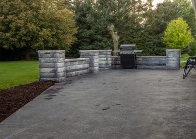 Landscape construction of patio and wall in homeowners back yard for a beautiful lounge area